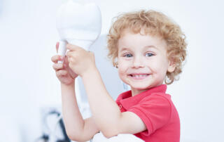 smiling kid with tooth at floss boss